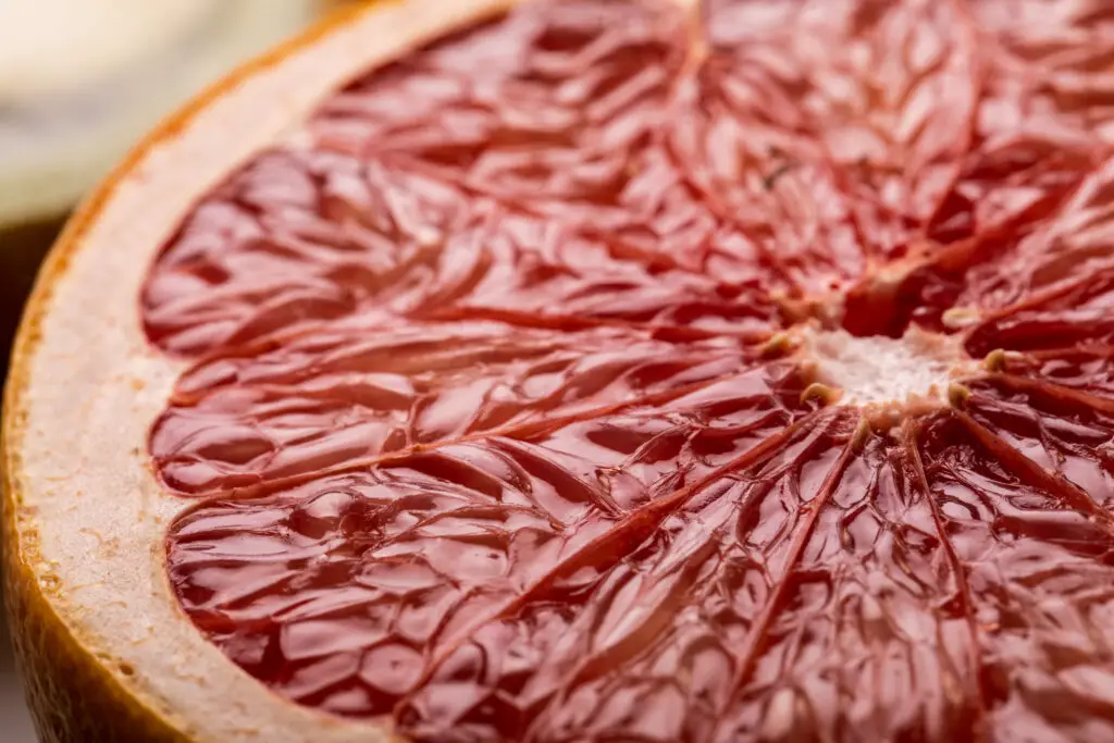 Closeup section of a grapefruit showing the fine texture of the fruit.