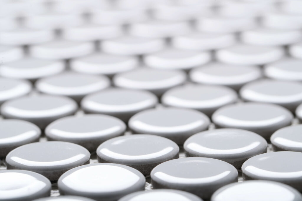 A macro photograph of smooth, glossy textured ceramic tile knobs .