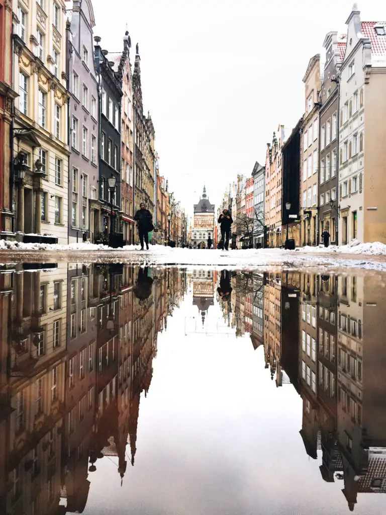 Mirror, or reflection symmetry in a photograph of a street reflected in a pool of water